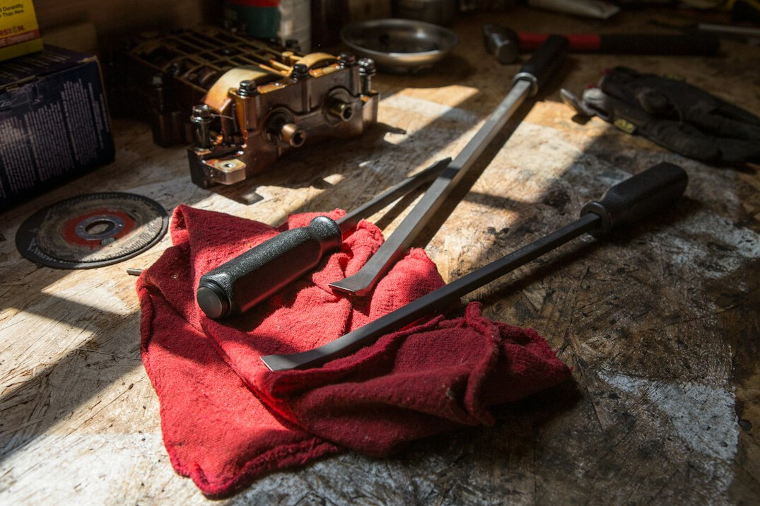 Garage workbench with tools and car parts